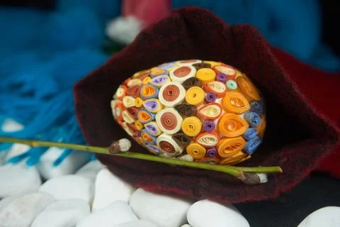 Easter egg on a red wool scarf Stock Photos