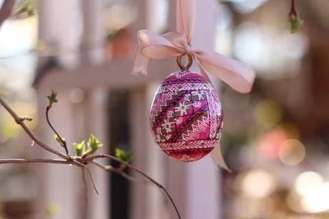 Easter egg on a ribbon on a blurred background Stock Photos