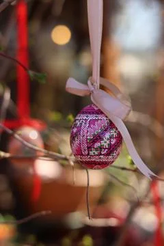 Easter egg on a ribbon on a blurred background. Wooden Easter egg Stock Photos