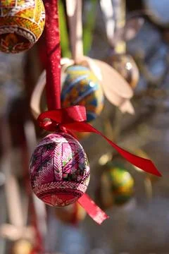 Easter egg on a ribbon on a blurred background Stock Photos