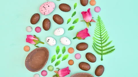 Easter egg shape made with chocolate eggs and spring accessories Stop motion. Stock Footage 233246018