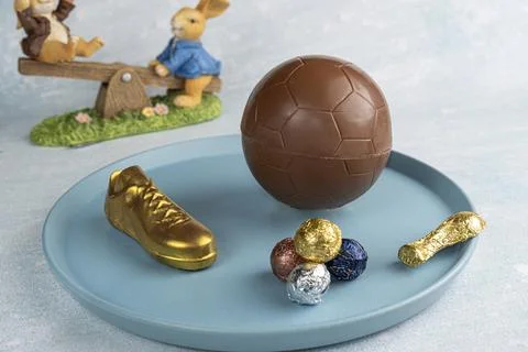 Easter egg in the shape of a soccer ball filled with small assorted chocola.. Stock Photos