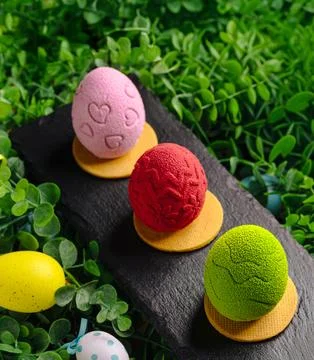 Easter egg shaped mousse cakes on slate Stock Photos