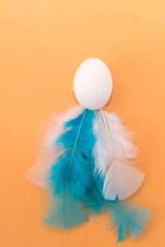 Easter egg with white feathers. colorful easter background. Pantone 스톡 사진