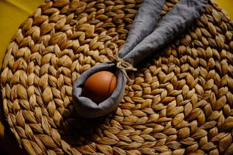 Easter egg wrapped into a rabbit with a napkin Stock Photos