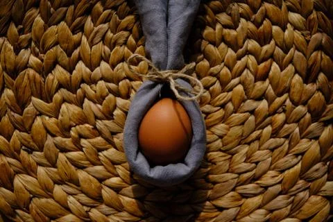Easter egg wrapped into a rabbit with a napkin Stock Photos