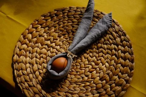 Easter egg wrapped into a rabbit with a napkin Stock Photos