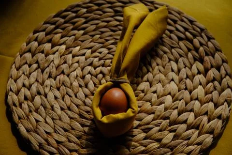 Easter egg wrapped into a rabbit with a napkin Stock Photos