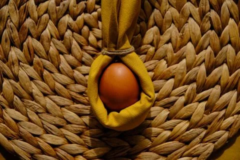 Easter egg wrapped into a rabbit with a napkin Stock Photos