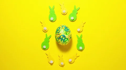 Easter egg on yellow background and rabbits stop motion animation Stock Footage 123808714