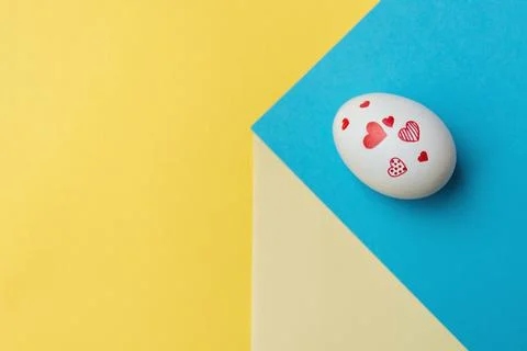 Easter egg on yellow-blue background 스톡 사진