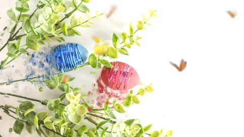 Easter eggs and a branch of greenery on a white background. Stock Footage 128277669