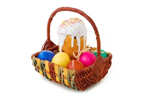 Easter eggs and cake in the wicker basket. Stock Photos