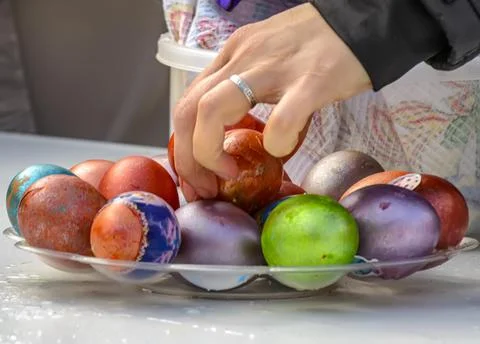 Easter eggs and cakes on lighting near the temple. Stock Photos