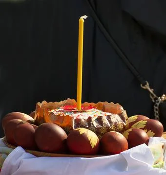 Easter eggs and cakes on lighting near the temple. Stock Photos