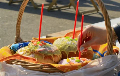 Easter eggs and cakes on lighting near the temple. Stock Photos