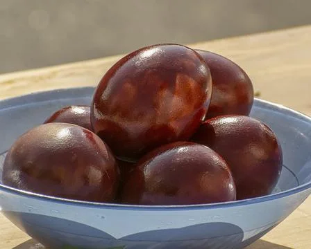 Easter eggs and cakes on lighting near the temple. Stock Photos
