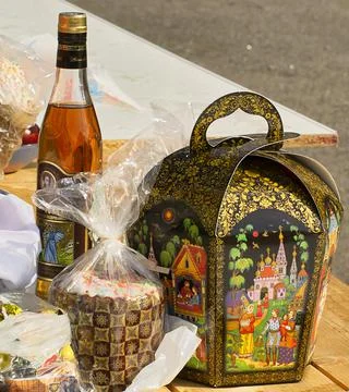 Easter eggs and cakes on lighting near the temple. Stock Photos