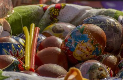 Easter eggs and cakes on lighting near the temple. Stock Photos
