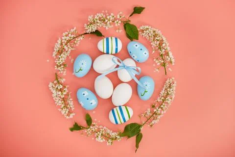 Easter eggs and cherry branches in the shape of a circle on a pink background Stock Photos