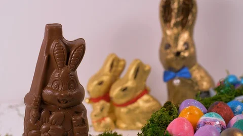 Easter Eggs And Chocolate Bunnies On White Background. Easter, Holiday Video stock 129092798