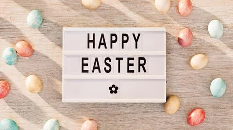 Easter eggs and cinema lightbox with holiday greeting Stock Photos