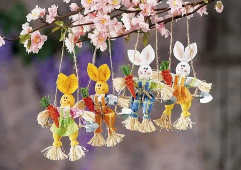 Easter eggs and cloth's rubbit hidden in natural straw nest Stock Photos
