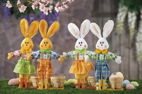 Easter eggs and cloth's rubbit hidden in natural straw nest Stock Photos