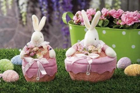 Easter eggs and cloth's rubbit hidden in natural straw nest Stock Photos