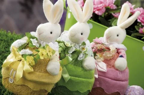 Easter eggs and cloth's rubbit hidden in natural straw nest Stock Photos