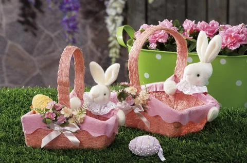 Easter eggs and cloth's rubbit hidden in natural straw nest Stock Photos