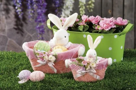 Easter eggs and cloth's rubbit hidden in natural straw nest Stock Photos