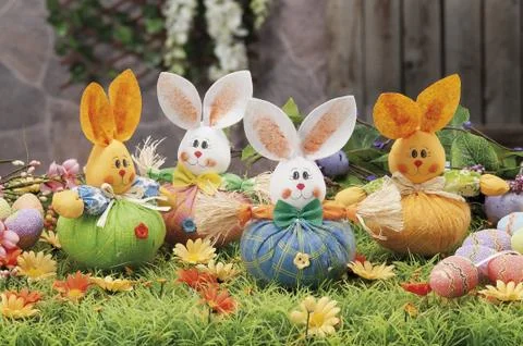 Easter eggs and cloth's rubbit hidden in natural straw nest Stock Photos