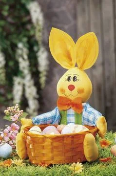 Easter eggs and cloth's rubbit hidden in natural straw nest Stock Photos