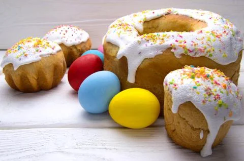 Easter eggs and different easter cake on white wooden table Stock Photos