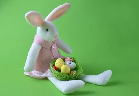 Easter eggs and easter bunny on a green background. Easter. Stock Photos