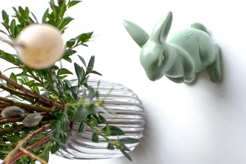 Easter eggs and easter bunny under willow and boxwood branches Stock Photos