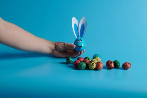 Easter eggs and egg with ears on a blue background Stock Photos