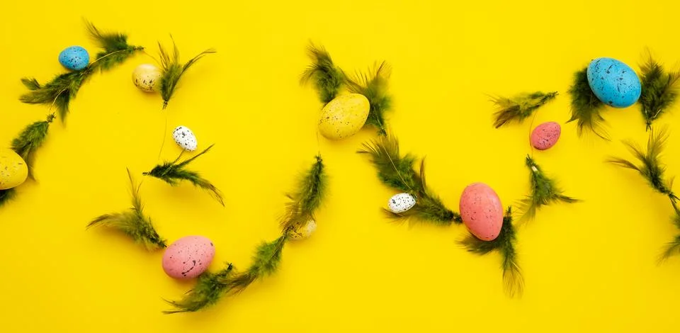 Easter eggs and feathers background, food top view Stock Photos