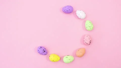 Easter eggs and feathers make circle with place for text. Stop motion Stock Footage 147734723
