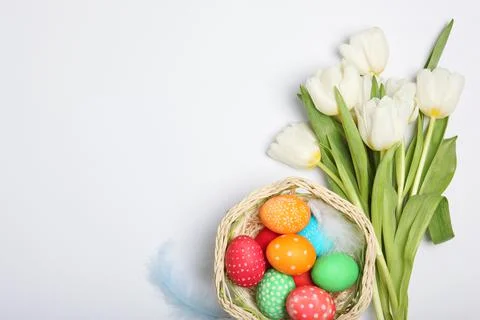Easter eggs and flowers on the table top view. Stock Photos