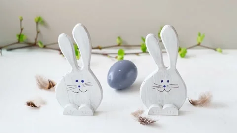 Easter eggs and funny bunnys. Easter egg are rolling, on white table. Happy Stock Footage 172607764
