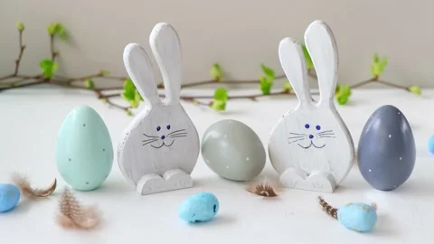 Easter eggs and funny bunnys on white table. Happy easter. Festive wooden Stock Footage