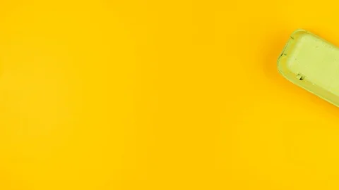 Easter eggs and Happy Easter paper letters on a yellow background Stock Footage 126298539