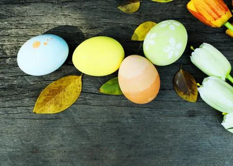 Easter eggs and leaves on old wood backgrounds above Stock Photos