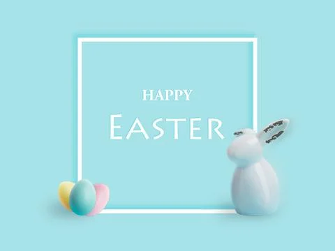 Easter eggs and rabbit on blue pastel background. Easter greeting card and white Foto stock