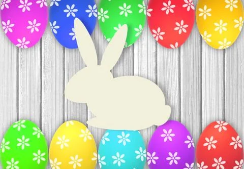 Easter eggs and rabbit over white wooden table Фото