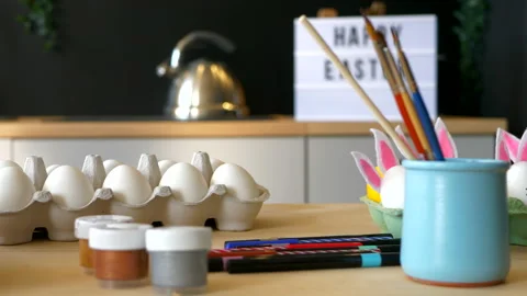 Easter eggs and set of paints and brushes for decorating them Stock Footage 151227499