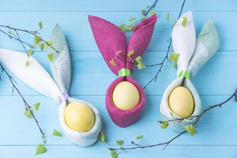 Easter eggs and the shape of rabbit ears and tree branches with green leaves, Stock Photos