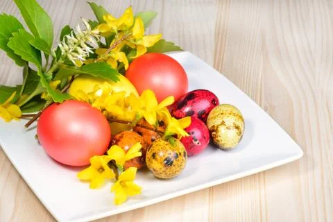 Easter eggs and spring flowers Stock Photos